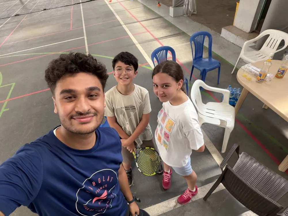 Coach Anthony Yaghi with two ProSpin students on court