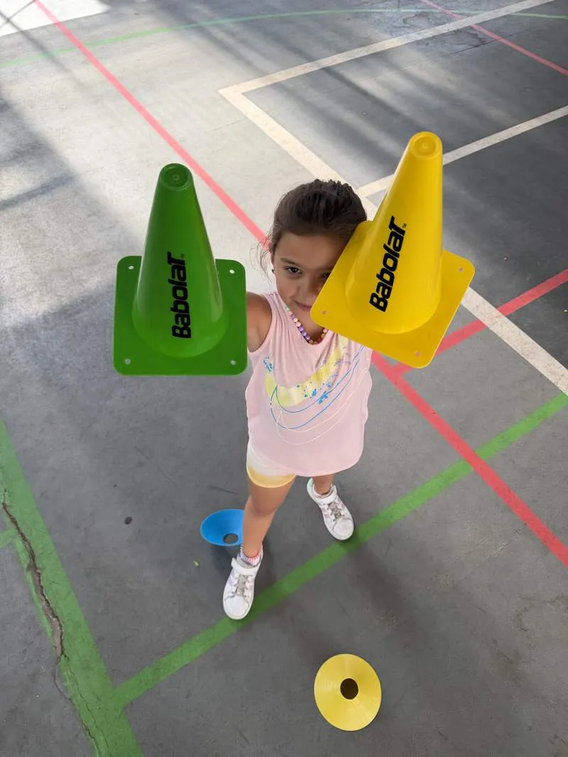Young player holding training cones during a drill